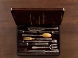 a wooden box with silverware in it on a table
