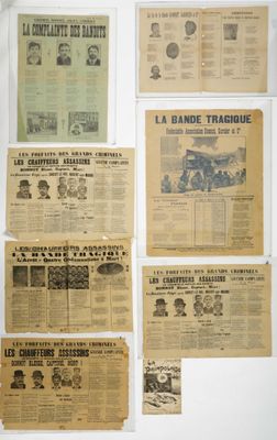 several old newspapers are displayed on a wall in a room