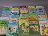 many children ' s books that are lined up on a table