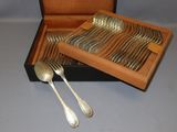 a wooden box with silverware in it on a table