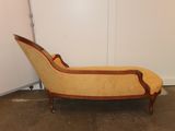 a chaise lounger in the corner of a room