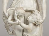 a statue of a woman holding a child and a statue of a man