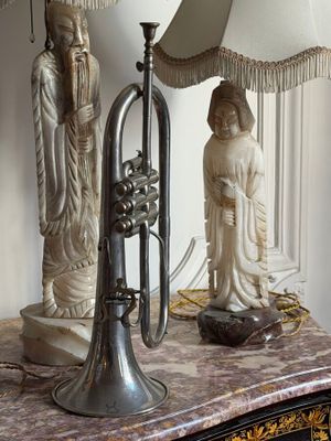 a table with a lamp and a trumpet on it