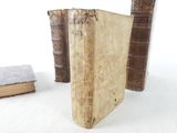 two old books sitting on a table next to each other