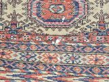 an old rug with a blue and red design on it
