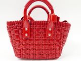 a red basket bag on a white background with a red handle