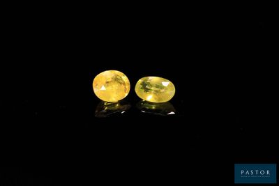 a pair of yellow sapphires on a black background