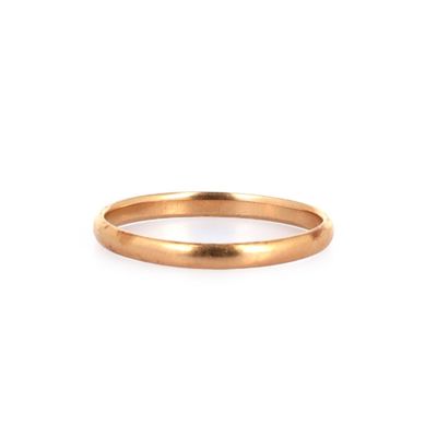 gros plan d'une bague en or sur fond blanc