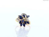 an image of a diamond and sapphire ring on a white surface
