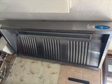 an image of a kitchen with a stove and a radiator