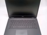 the dell laptop is open and ready to be used on the desk