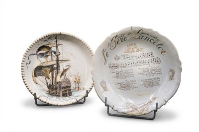 two plates that have a picture of a ship on them