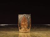 a glass with a picture of a man on it sitting on a table