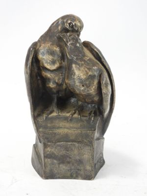 statue of a bird on a pedestal with a white background