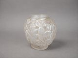 a white glass vase with a flower design on it
