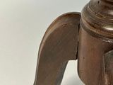 a close up of a wooden table with a vase on top of it