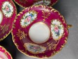 four cups and saucers with flowers on them