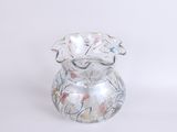a glass vase that has a flower design on it