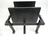 a black chair that has a metal frame on top of it