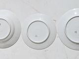 three plates that are sitting on a white table