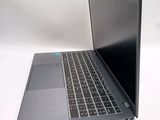 a laptop that is open on a white surface