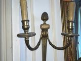 two lamps that are on the wall next to each other