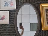 a person taking a picture of a mirror with a cell phone