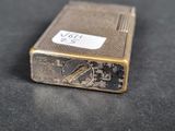 a silver lighter that is sitting on a table