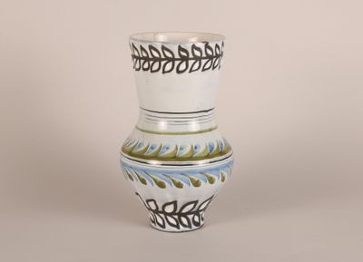 a white vase with a blue and green design on it