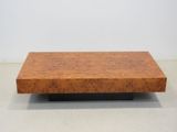 a wooden coffee table with a black base and a brown top