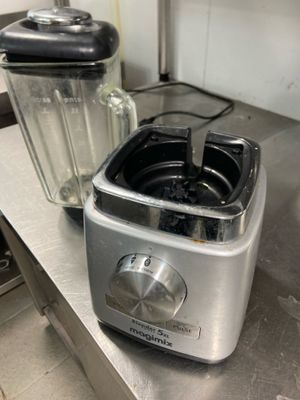 two blenders sitting on a counter in a kitchen