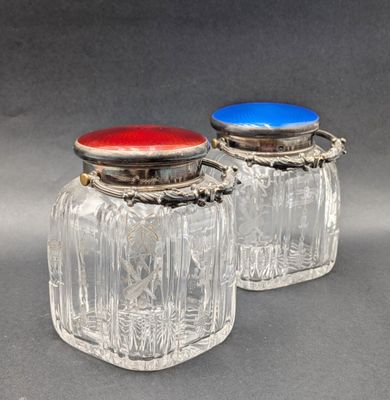 pair of cut glass salt and pepper shakers with red, white and blue lids