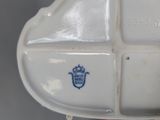 a close up of a white plate with a blue emblem on it