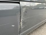 a close up of a car ' s paint job on the side of the road