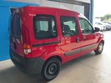 a red van parked in a garage with a blue wall