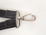 a close up of a black strap with a metal hook