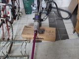a vacuum that is sitting on the floor next to a bike