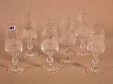 six wine glasses sitting next to each other on a table