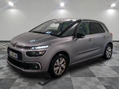 the grey citrole is parked on a checkered tile floor