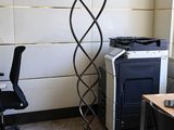 a lamp that is sitting on a stand in the corner of a room