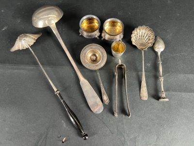 a lot of silver spoons and utensils on a table