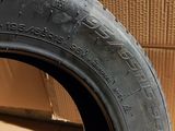 the tire of a motorcycle is sitting on the floor next to a cardboard box