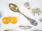 many different types of jewelry on a white surface