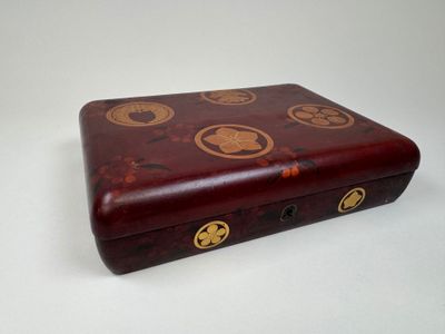 a wooden box with a design on it on a white surface