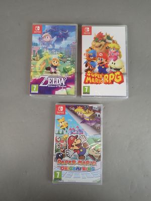 three nintendo wii games are sitting on a table next to each other