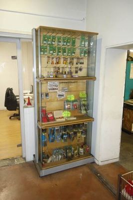 a glass display case in the corner of a room