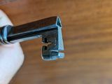 a person holding a key in their hand on a wooden table