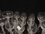 many empty wine glasses lined up on a table
