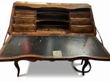a desk with a black top and a wooden top