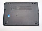the back of a laptop with a blue sticker sitting on top of it